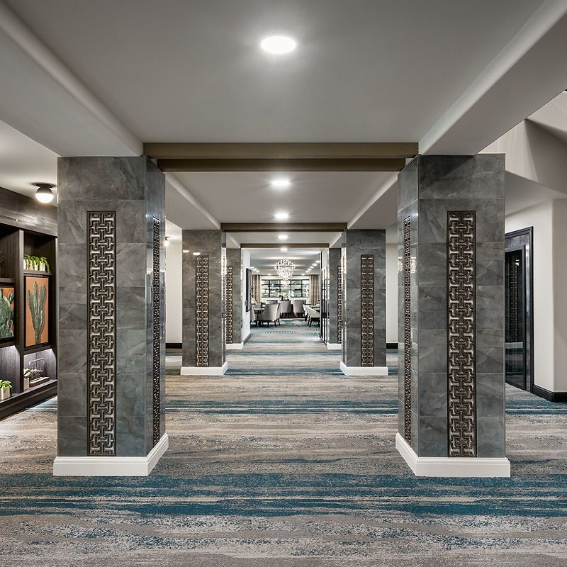 A modern hotel hallway with sleek architectural elements and stylish decor.