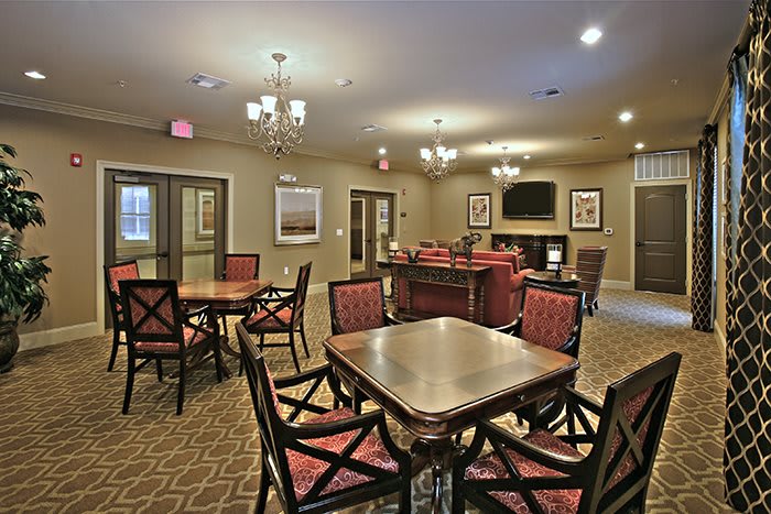 A cozy lounge area with stylish furniture and chandeliers, providing a welcoming atmosphere.
