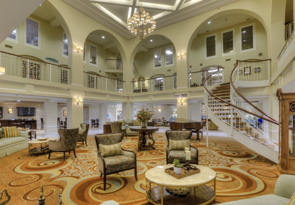 Elegant and spacious hotel lobby with luxurious decor and a grand staircase.