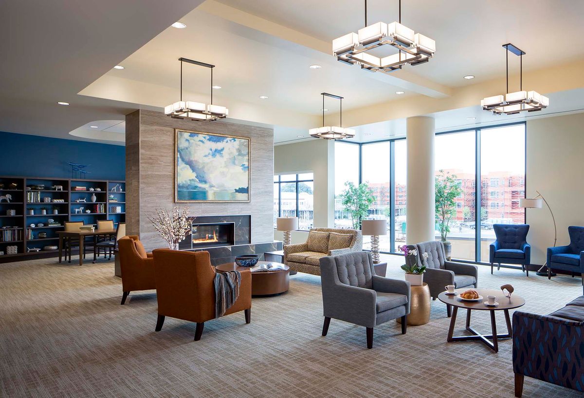 A modern lobby with comfortable seating and large windows.