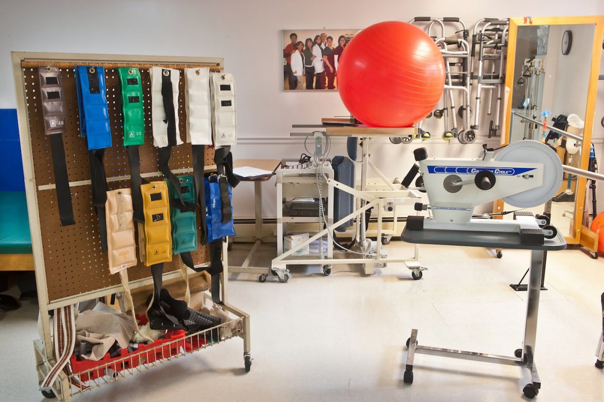 A physical therapy room equipped with various rehabilitation tools and exercise equipment.