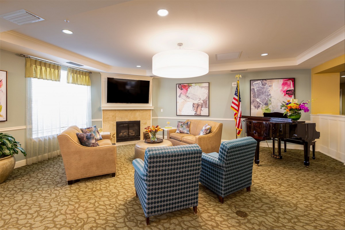 A cozy living room with a fireplace, television, and comfortable seating arrangement.