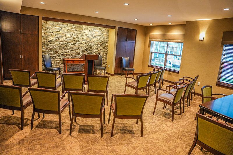 A small conference room with arranged seating and a podium for presentations.