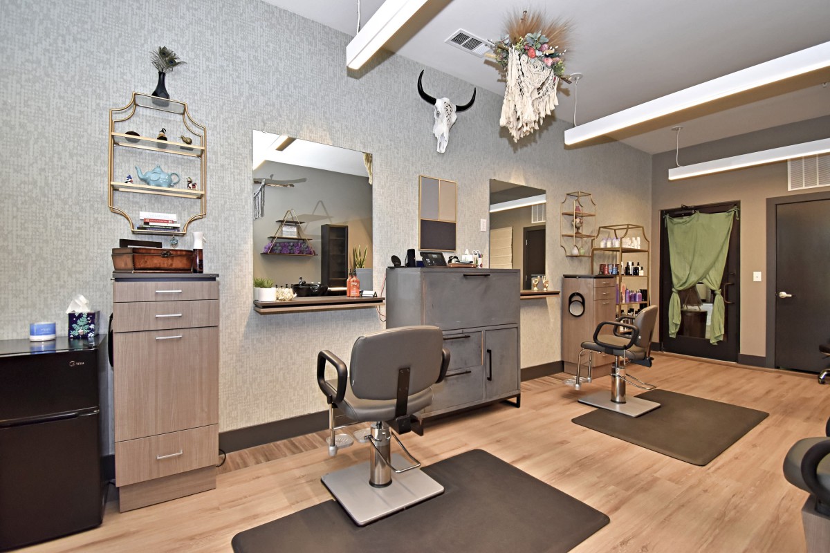 Modern hair salon interior with styling stations and mirrors.