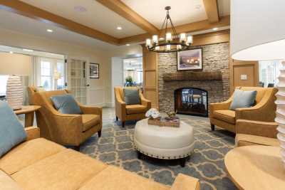 A cozy living room with a fireplace, comfortable seating, and elegant decor.