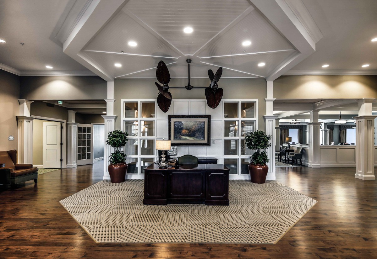 An elegant office reception area with plants and stylish decor.