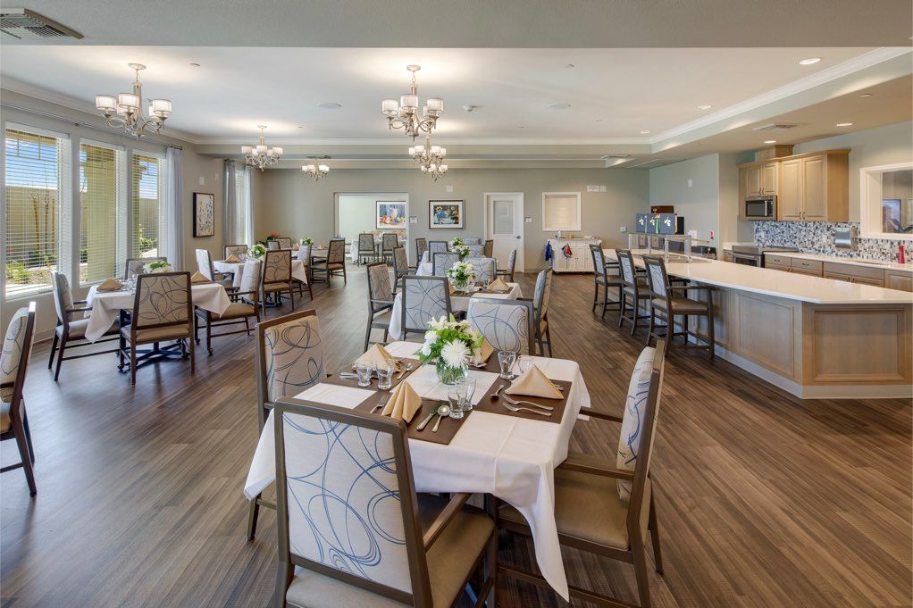 A modern dining area with elegantly set tables and comfortable seating.