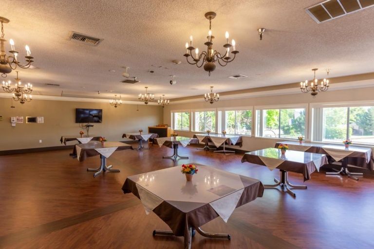 A spacious dining area with elegantly set tables and natural lighting.