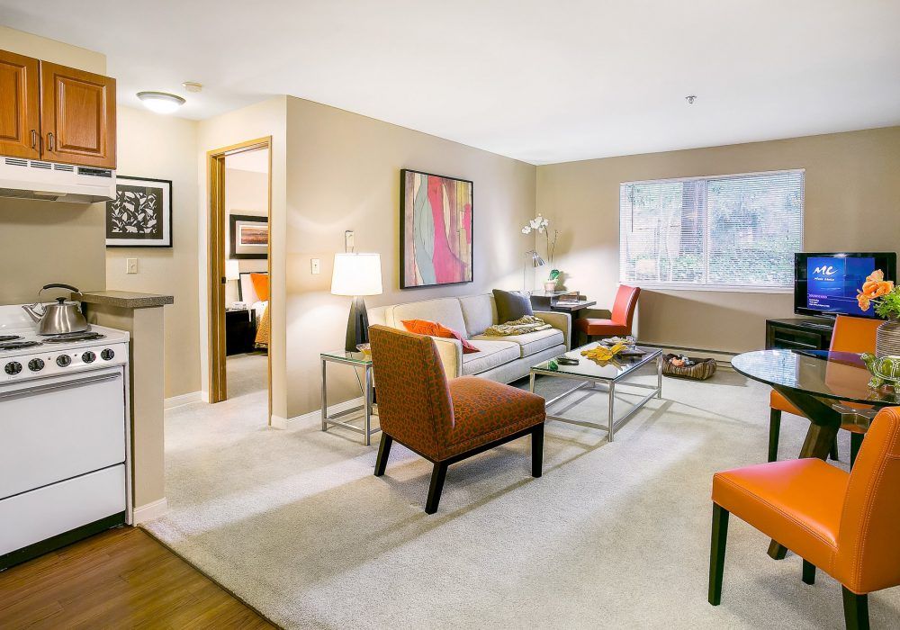 A modern and cozy living room with stylish furniture and artwork.