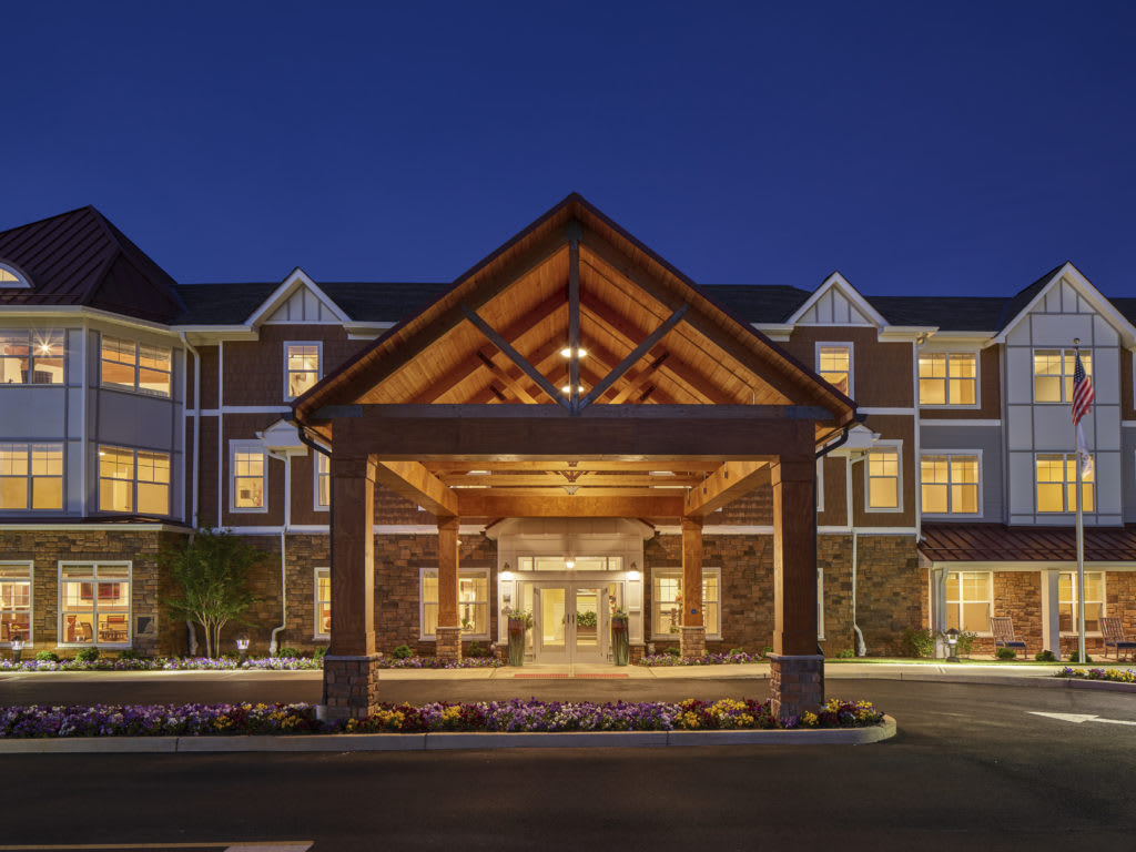 A well-lit hotel entrance at night showcasing elegant architecture.