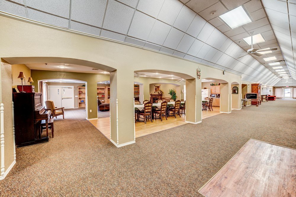 A modern and spacious lobby with seating areas and arched entryways.