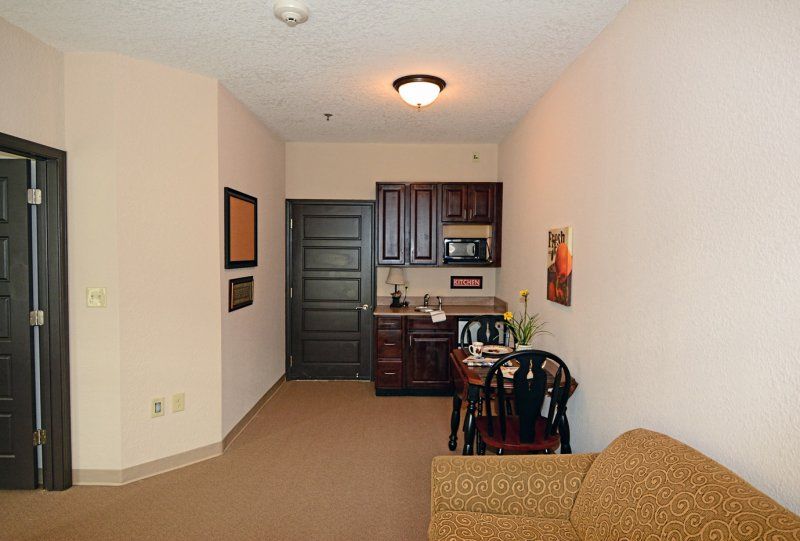 A cozy apartment interior with a kitchenette and dining area.