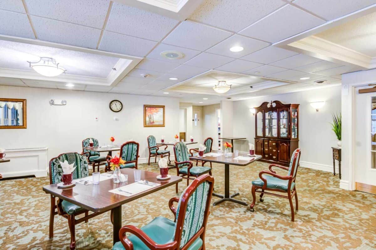 A spacious dining room with elegant furniture and decor.