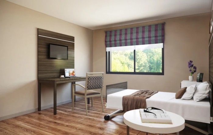 A modern and minimalist bedroom interior with a desk, chair, and bed near a window.