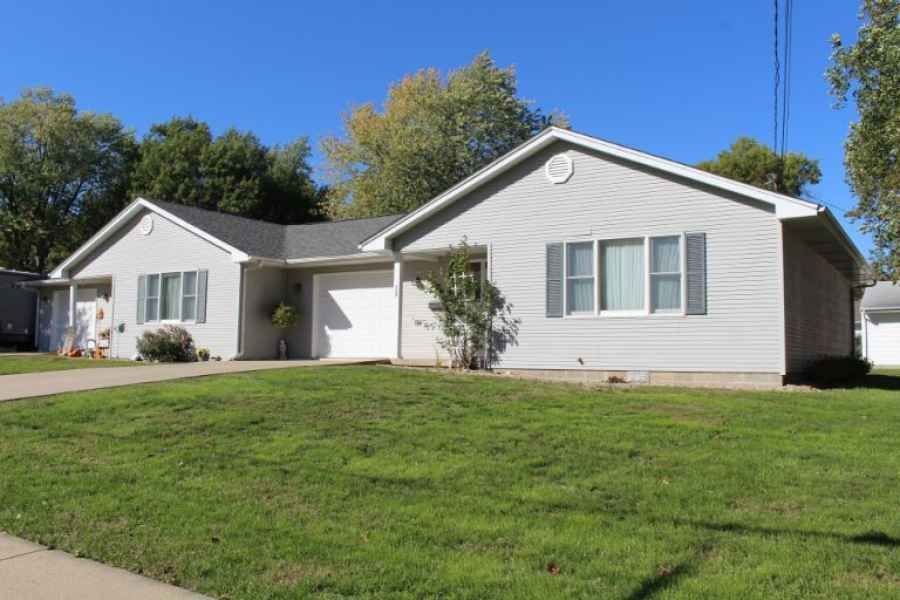 A single-story suburban house with a well-maintained lawn.