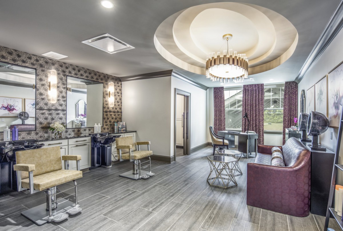 A modern and stylish salon interior with chic furniture and lighting.