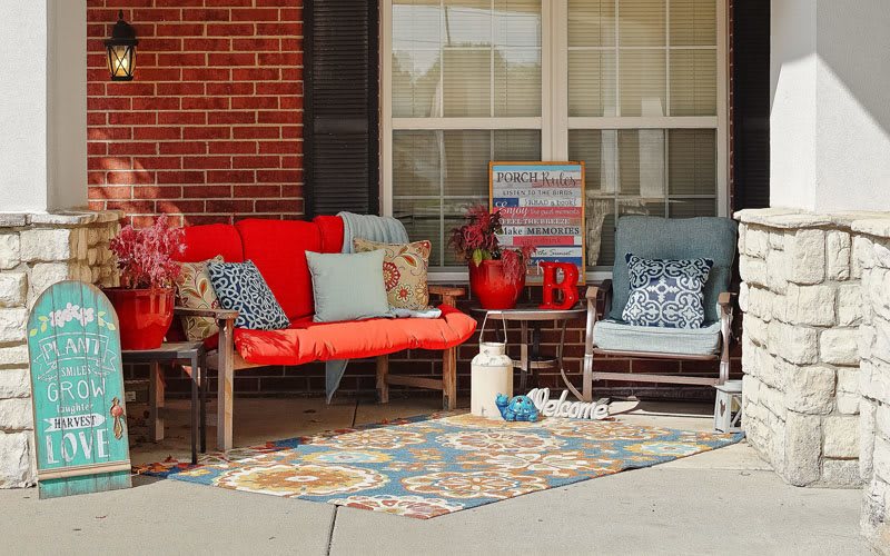 A cozy outdoor patio setup with colorful cushions and decor.