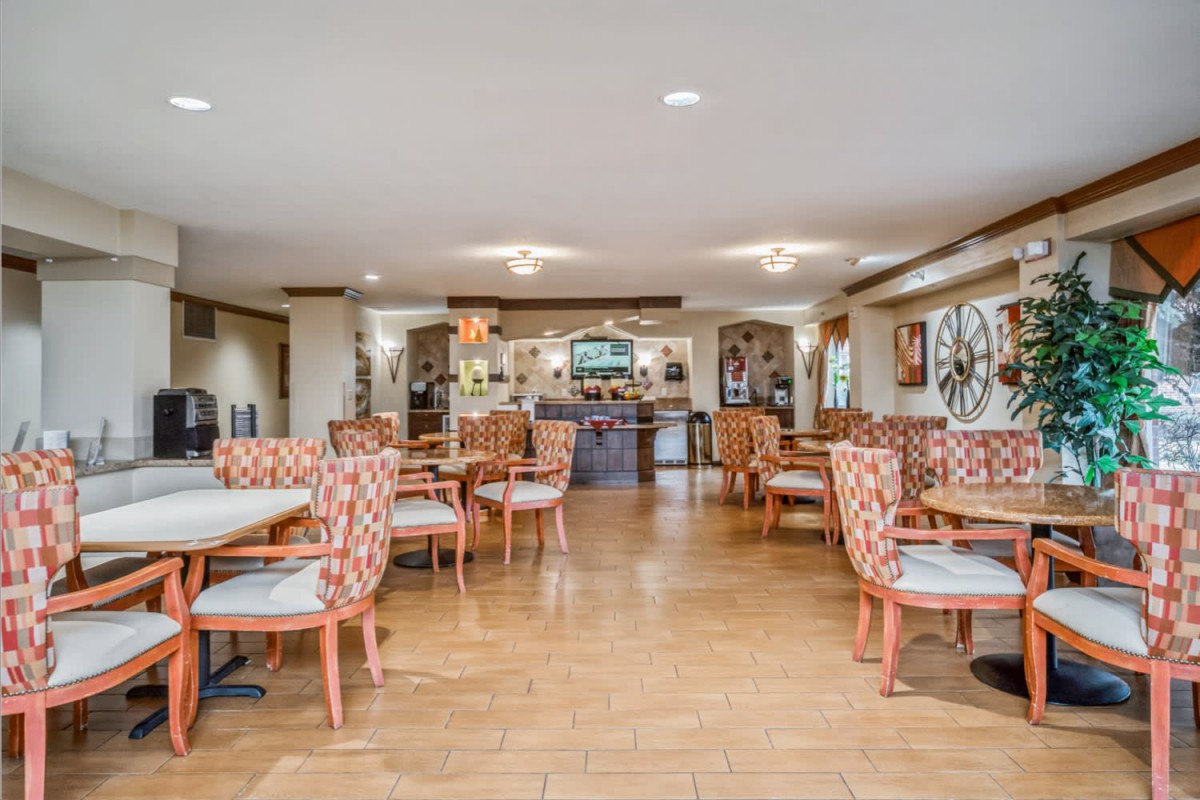 A well-arranged dining area with multiple tables and chairs, offering a cozy atmosphere.