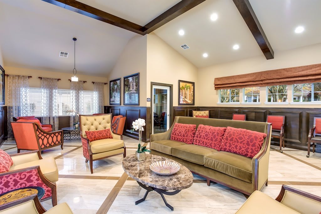 A stylish living room with elegant furniture and a vaulted ceiling.