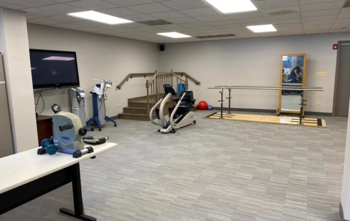 A fitness facility featuring various exercise machines and rehabilitation equipment.