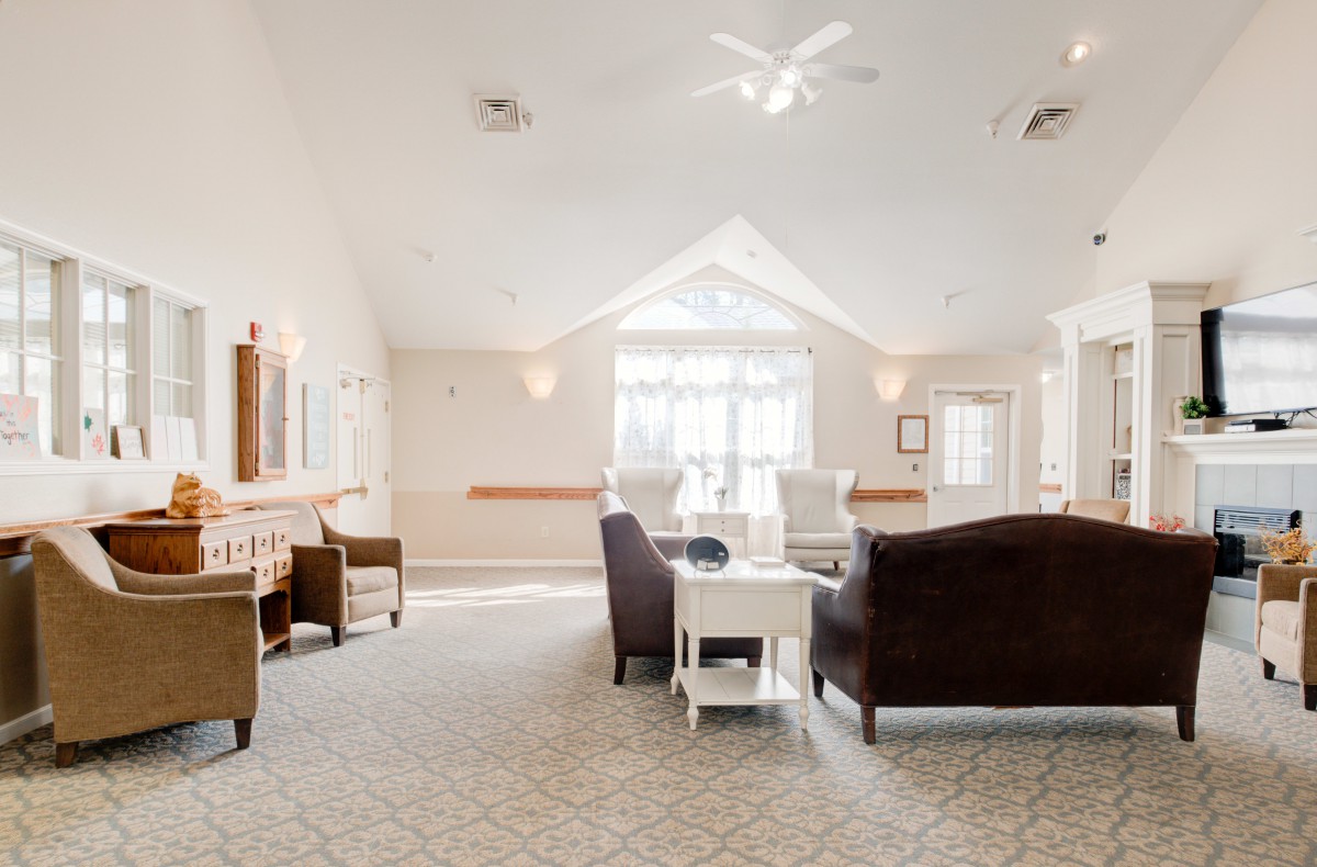A spacious living room with comfortable seating and large windows.
