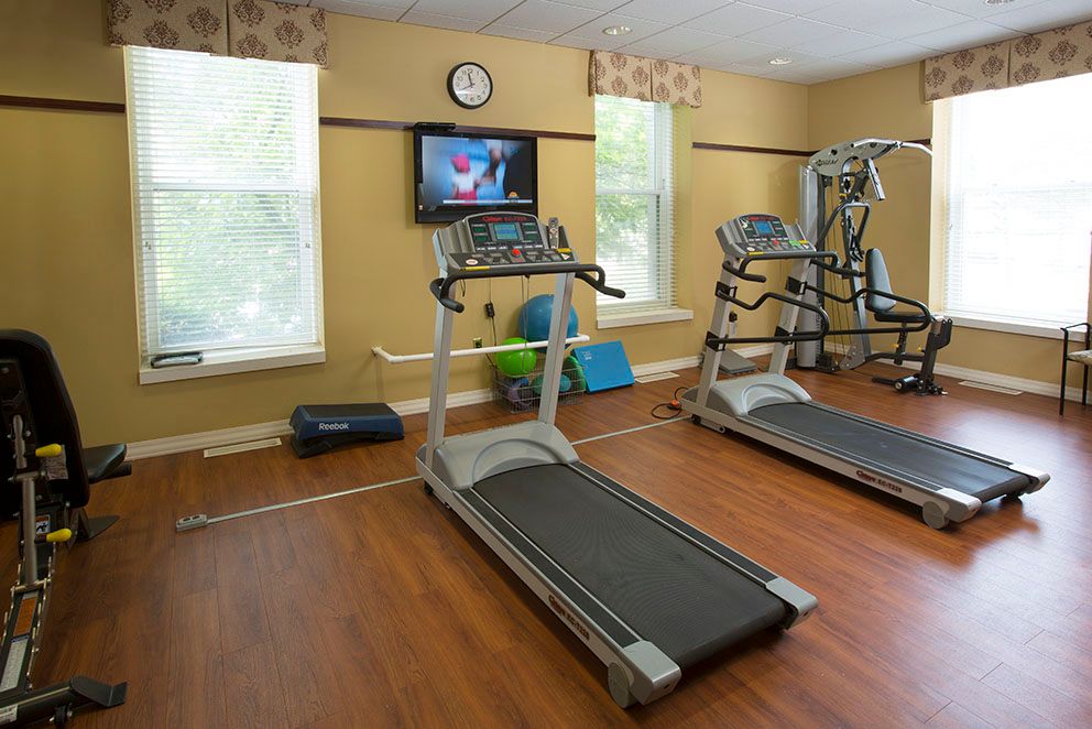 A small gym with treadmills and exercise equipment.