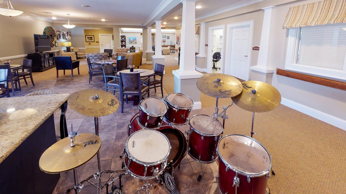 A drum set in a music room with seating arrangements.