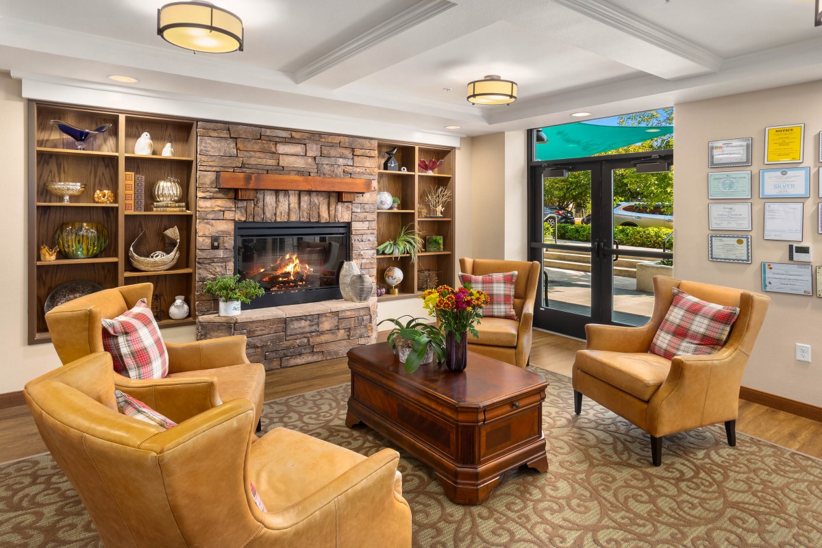 A cozy living room with a fireplace and comfortable seating.
