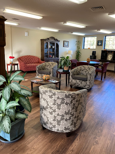 A cozy lounge area featuring comfortable seating and decorative plants.