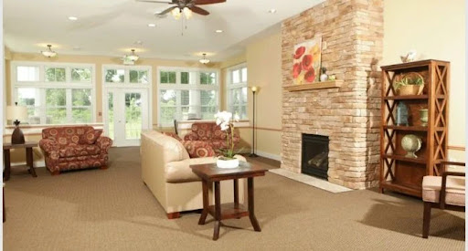 A cozy and inviting living room featuring a comfortable sofa, decorative fireplace, and ample natural light.
