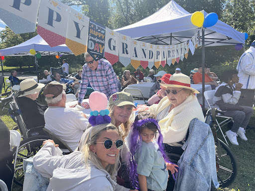 A joyful gathering celebrating grandparents with family, laughter, and colorful decorations.