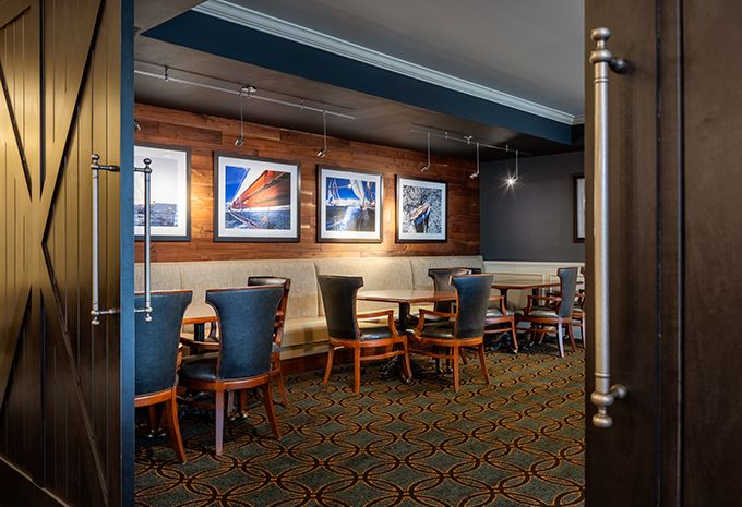 A modern restaurant dining area with stylish seating and art-adorned walls.