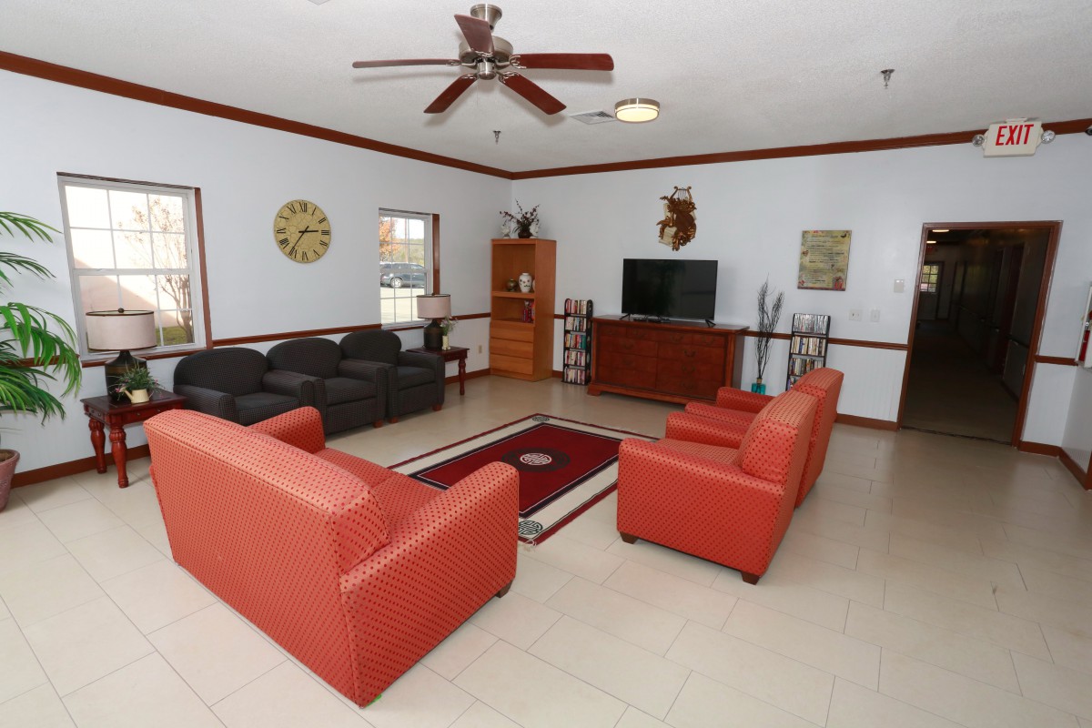 A spacious living room with modern furniture and decor.
