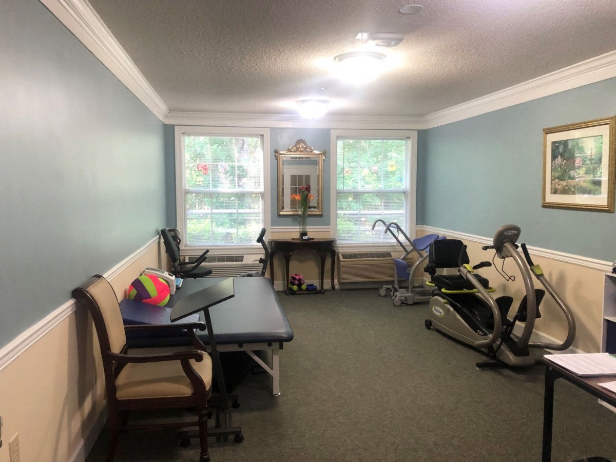A physical therapy room equipped with various rehabilitation equipment and exercise machines.