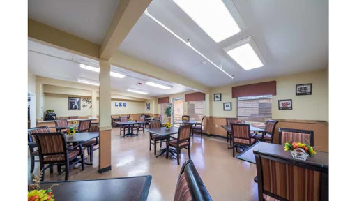 A spacious dining area with tables and chairs, designed for social gatherings.