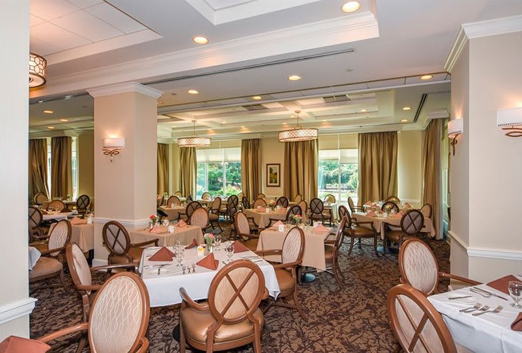 An elegant dining room with neatly arranged tables and chairs, ready for guests.
