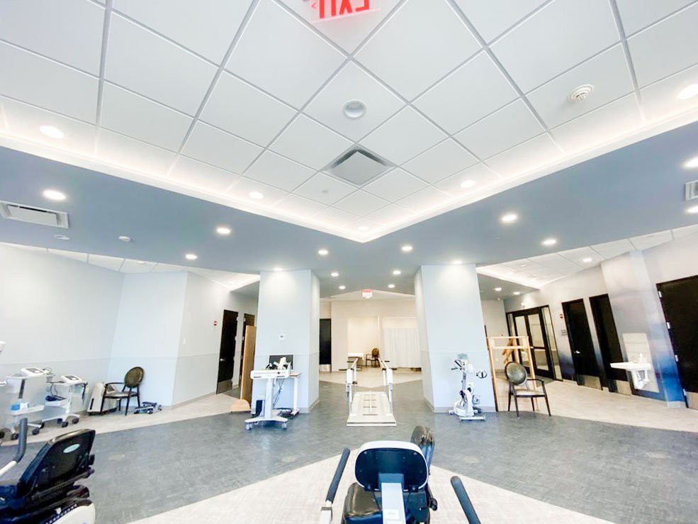 A modern and well-lit fitness center interior with various exercise equipment.