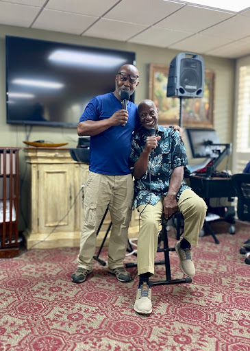 Two friends enjoying a musical moment together with microphones in hand.