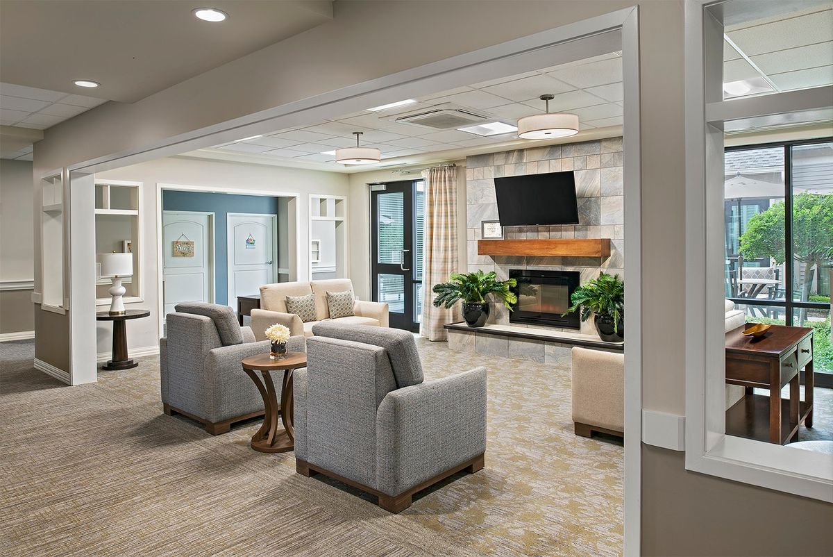 A modern living room with comfortable seating, a fireplace, and a wall-mounted television.
