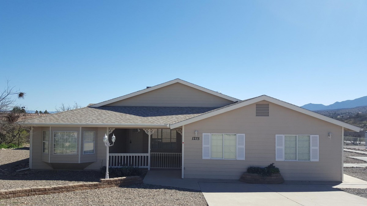 A suburban residential house with a driveway and front porch.