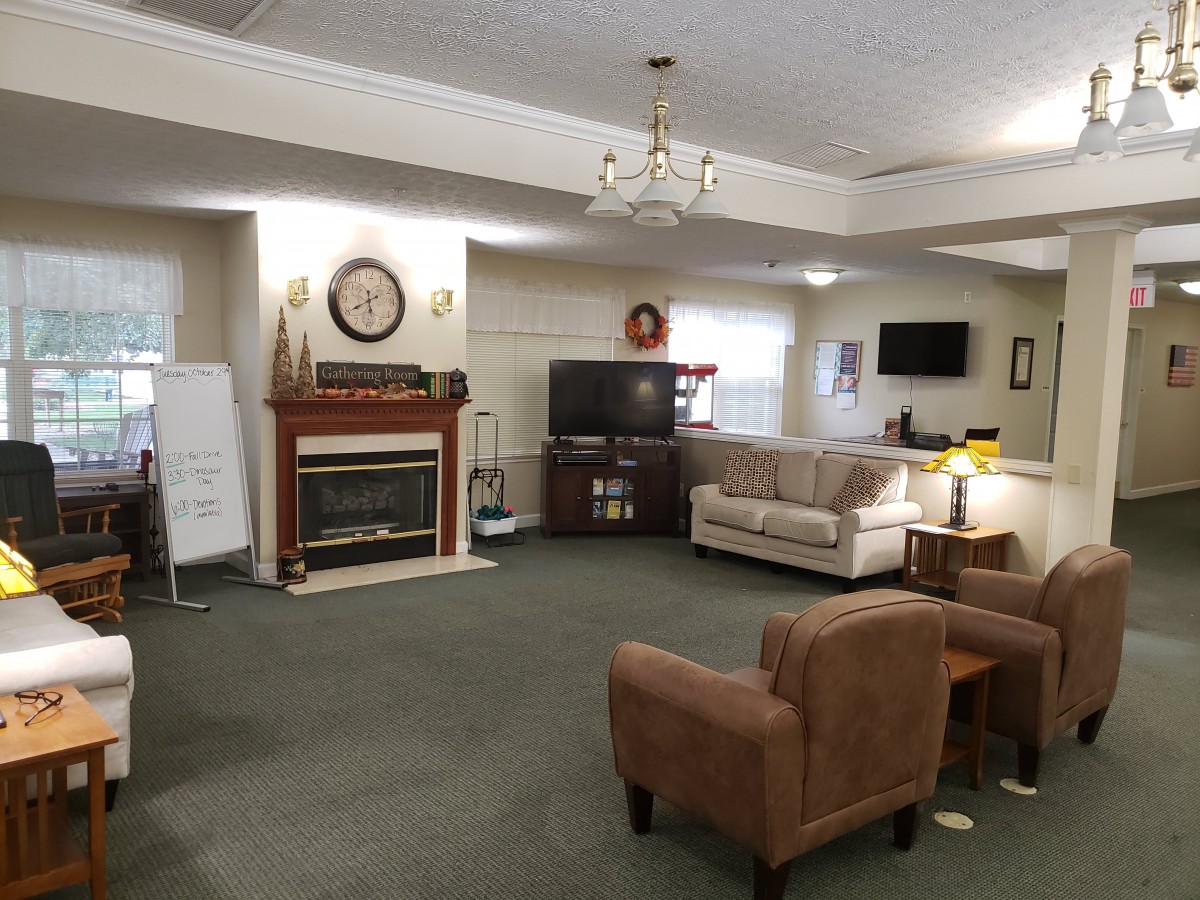 A cozy living room with a fireplace, television, and comfortable seating.