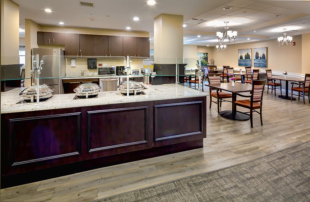 A modern kitchen and dining area with wooden flooring and stylish furnishings.