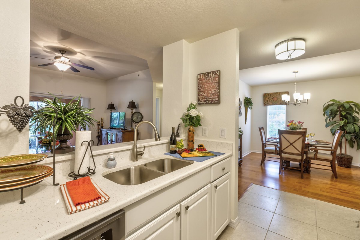 A modern kitchen with a view into the dining and living areas.