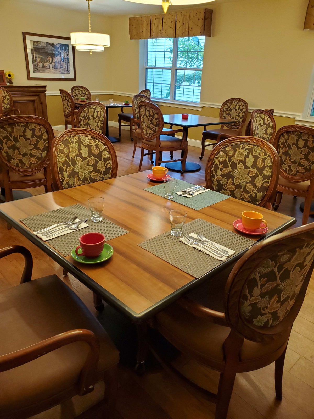 A cozy dining area with elegantly set tables ready for guests.