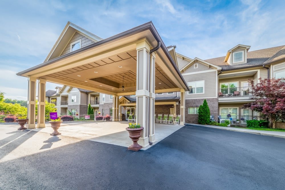 A well-maintained residential building with a covered entrance and driveway.