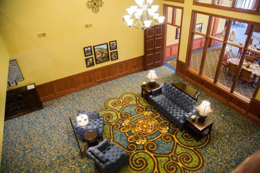 A cozy hotel lobby featuring elegant furniture and decorative elements.