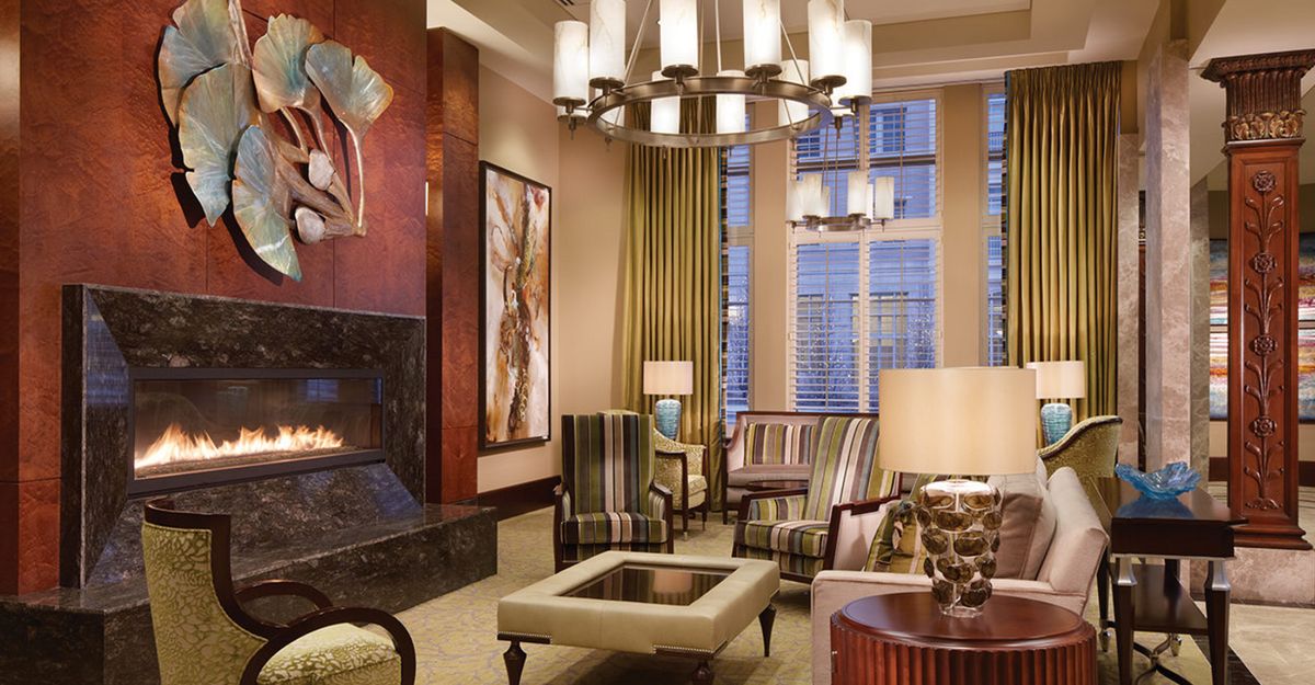 A modern living room featuring a cozy fireplace, stylish furniture, and elegant lighting.