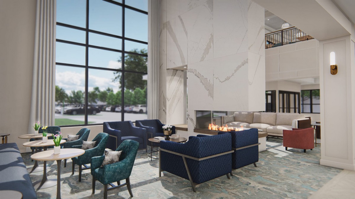 A modern lobby with comfortable seating and a fireplace.