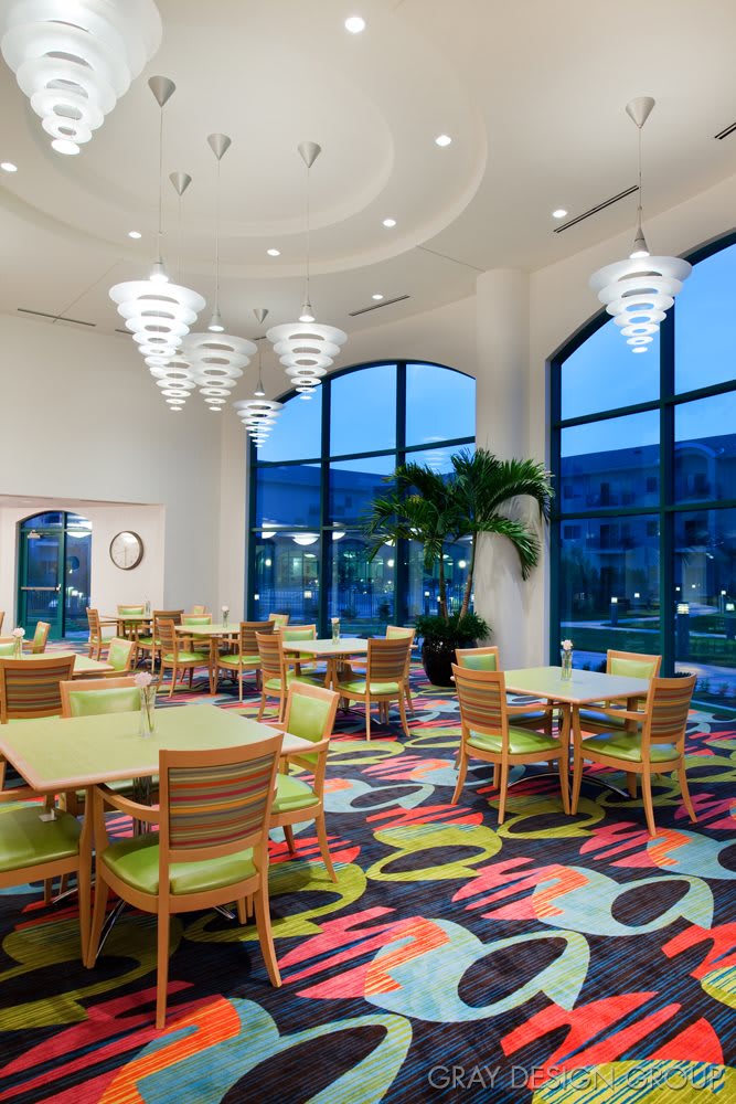 A modern restaurant interior with vibrant colors and decorative lighting.