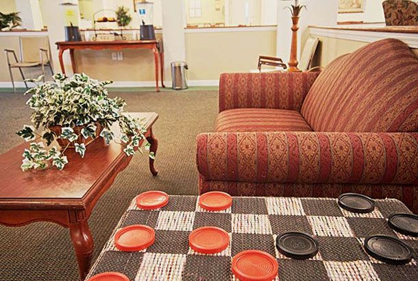 A cozy living room with a checkers game setup on the coffee table.